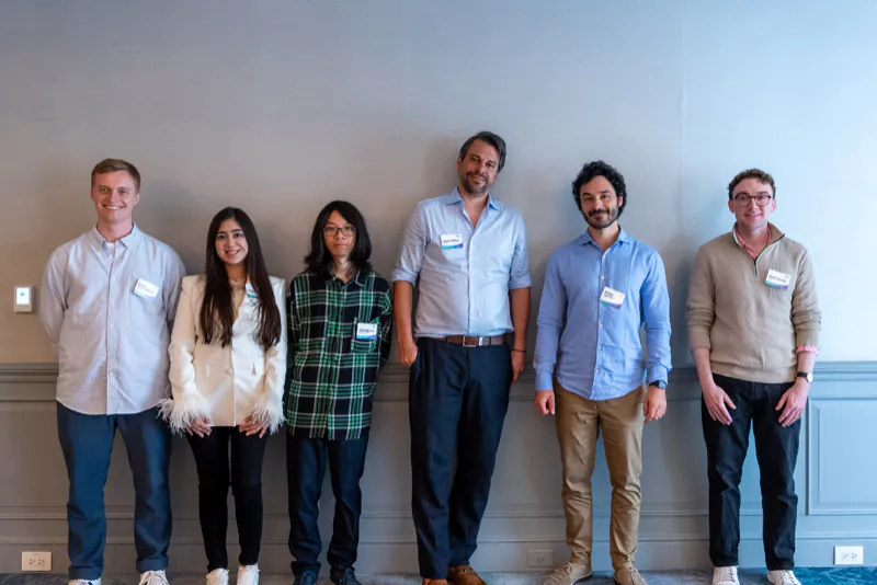 Six red-team members standing in a row at the Boston showcase