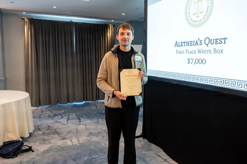 Serhii Honcharenko of team FlaiChi holding the team’s second-place white-box certificate